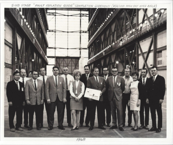 Group photo of personnel who assisted in production of the “Fault Isolation” document that was written by five engineers in 1968. This document was to be used for automating troubleshooting on the various systems of the Saturn V third stage called S-IVB built by MDAC. Jim was one of the five engineers responsible for producing description and schematics for the J2 engine, telemetry, and measuring systems. Photo taken in the transfer aisle of the massive Vehicle Assembly Building at KSC.