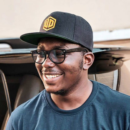 Joshua Oluwagbemiga modeling the User Defenders Snapback Hat